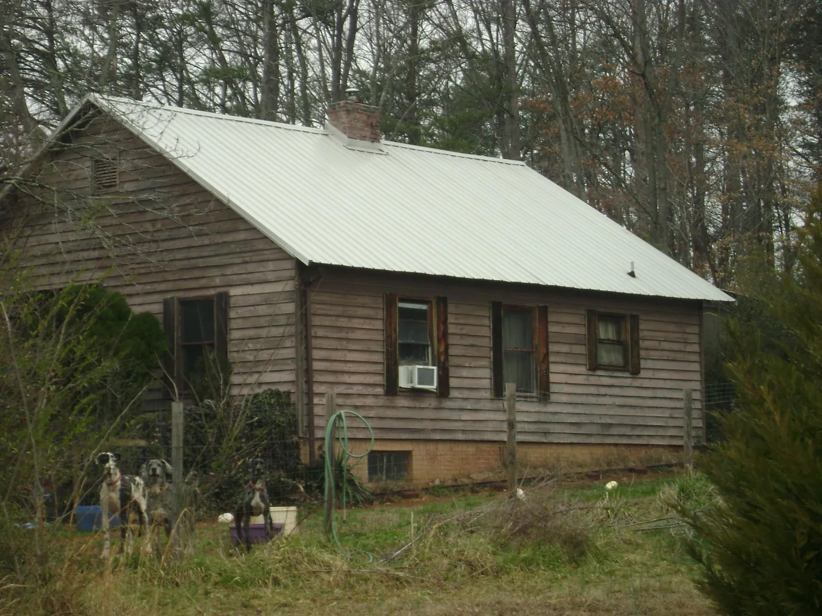 White metal roof on an old wood sided farmhouse, from a Metal Roof Installation job in Modena